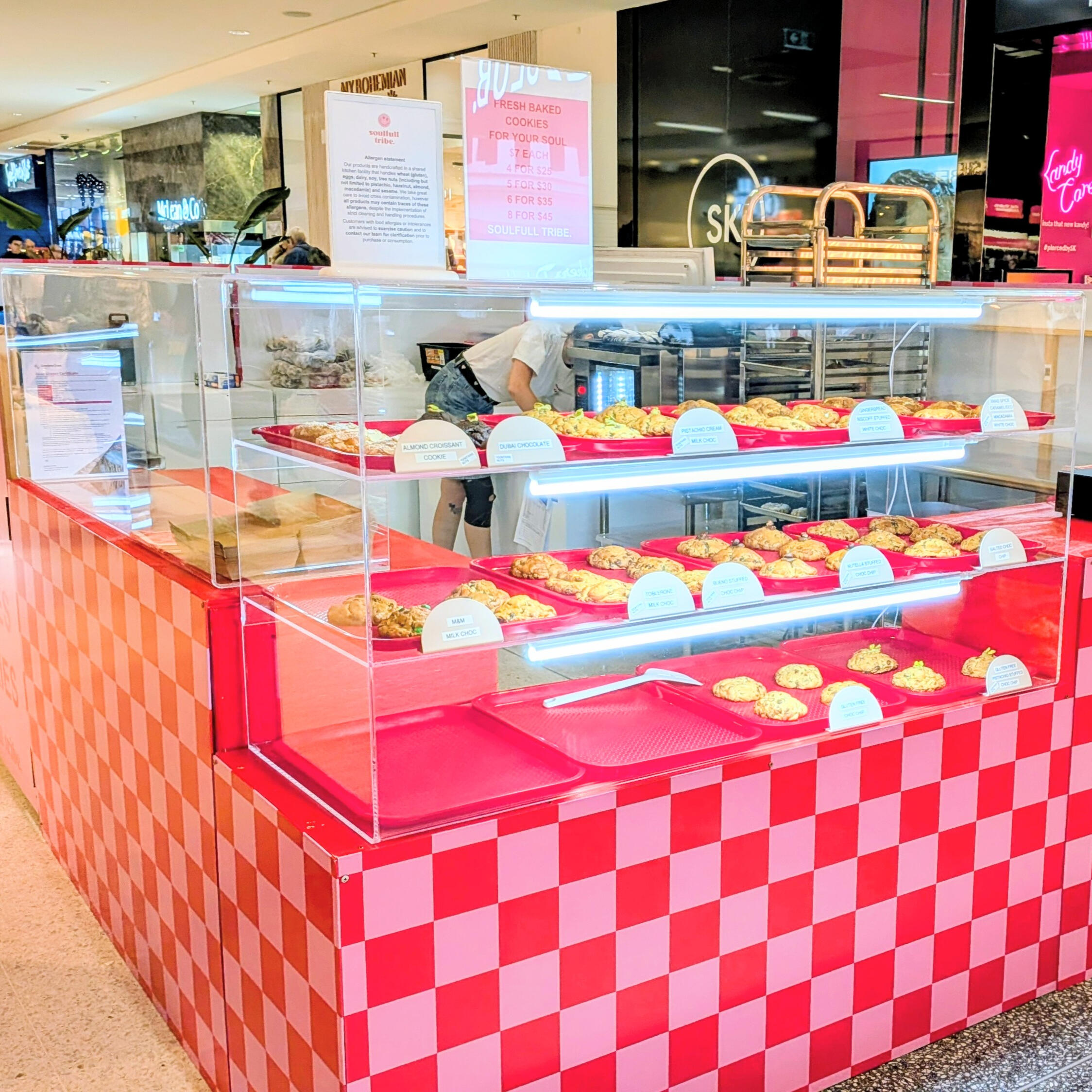 Clear Perspex acrylic food display case with biscuits or muffins inside
